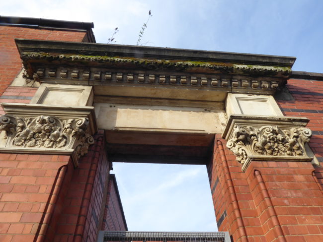 Ornate doorway with classical mouldings and details.